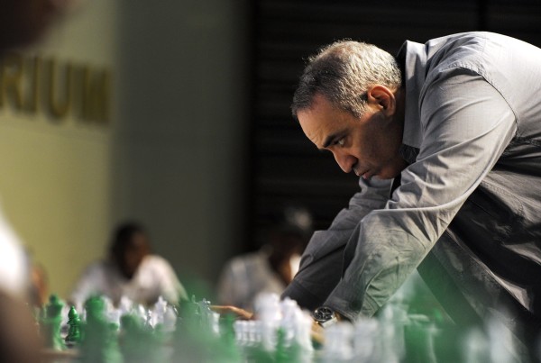 JOHANNESBURG, SOUTH AFRICA - MARCH 25: (SOUTH AFRICA OUT) Former World Chess Champion Garry Kasparov plays a game of chess with school children on March 25, 2012in Pretoria, South Africa. Kasparov played against 25 young players in less than 100 minutes. Kasparov is in the country as the guest of local chess education project Moves for Life (MFL). A branch of the Kasparov Chess Foundation (KCF) has been established in South Africa with the objective of taking the successful MFL chess initiative into other African countries. (Photo by Foto24/Gallo Images/Getty Images)