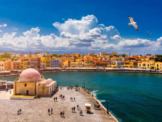 Mosque in the old Venetian harbor of Chania town on Crete island, Greece. Old mosque in Chania. Janissaries or Kioutsouk Hassan Mosque in Chania Crete. Turkish mosque in Chania bay. Crete, Greece.